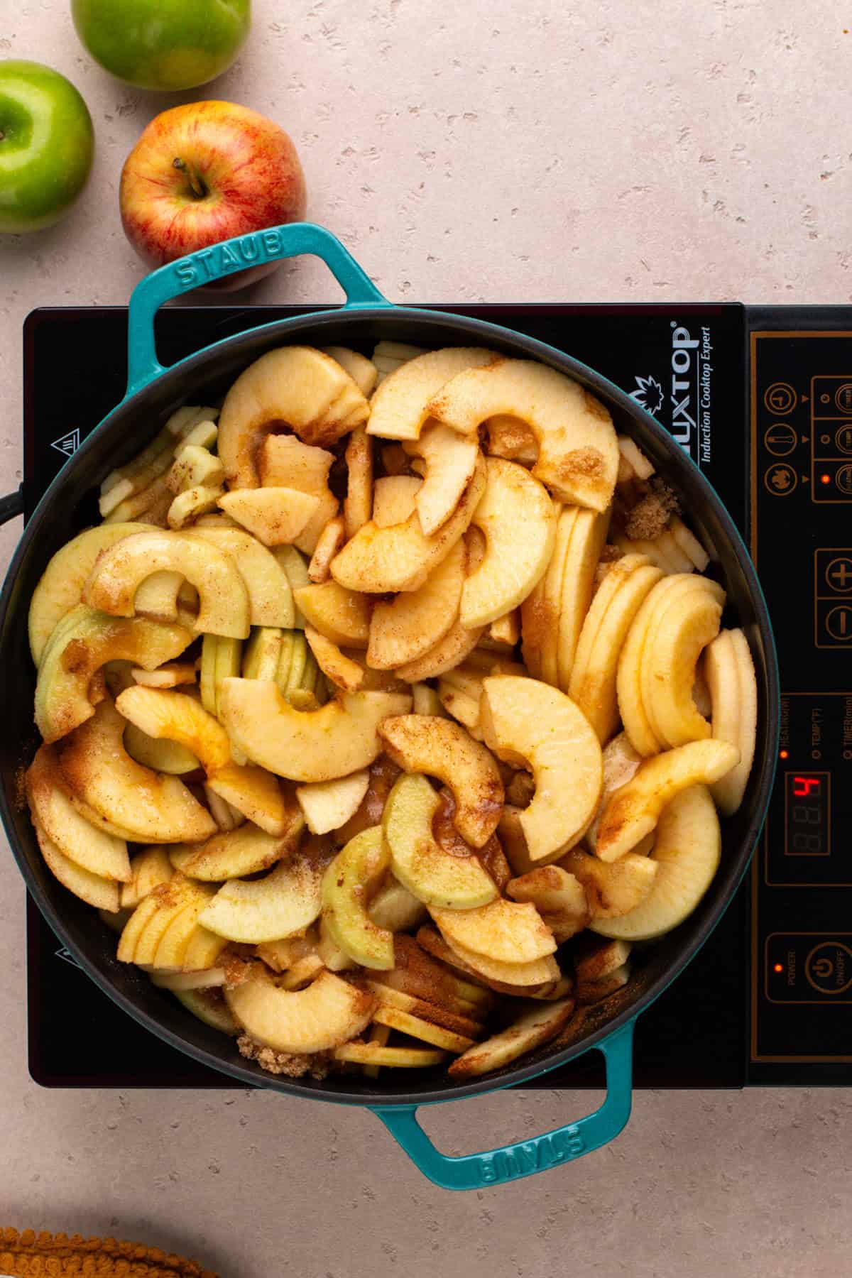 Ingredients for stovetop apple butter mixed in a large dutch oven.