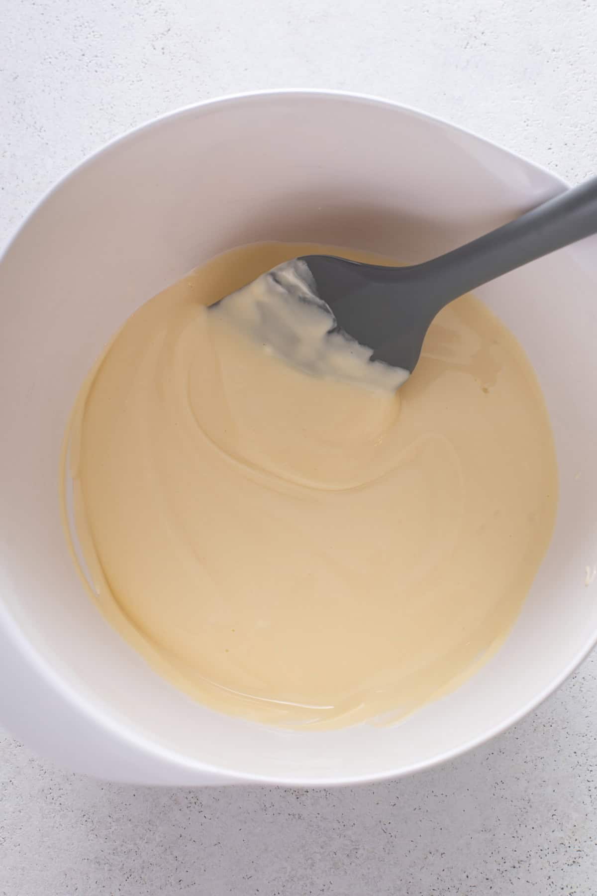 Cream cheese filling mixed in a white bowl.