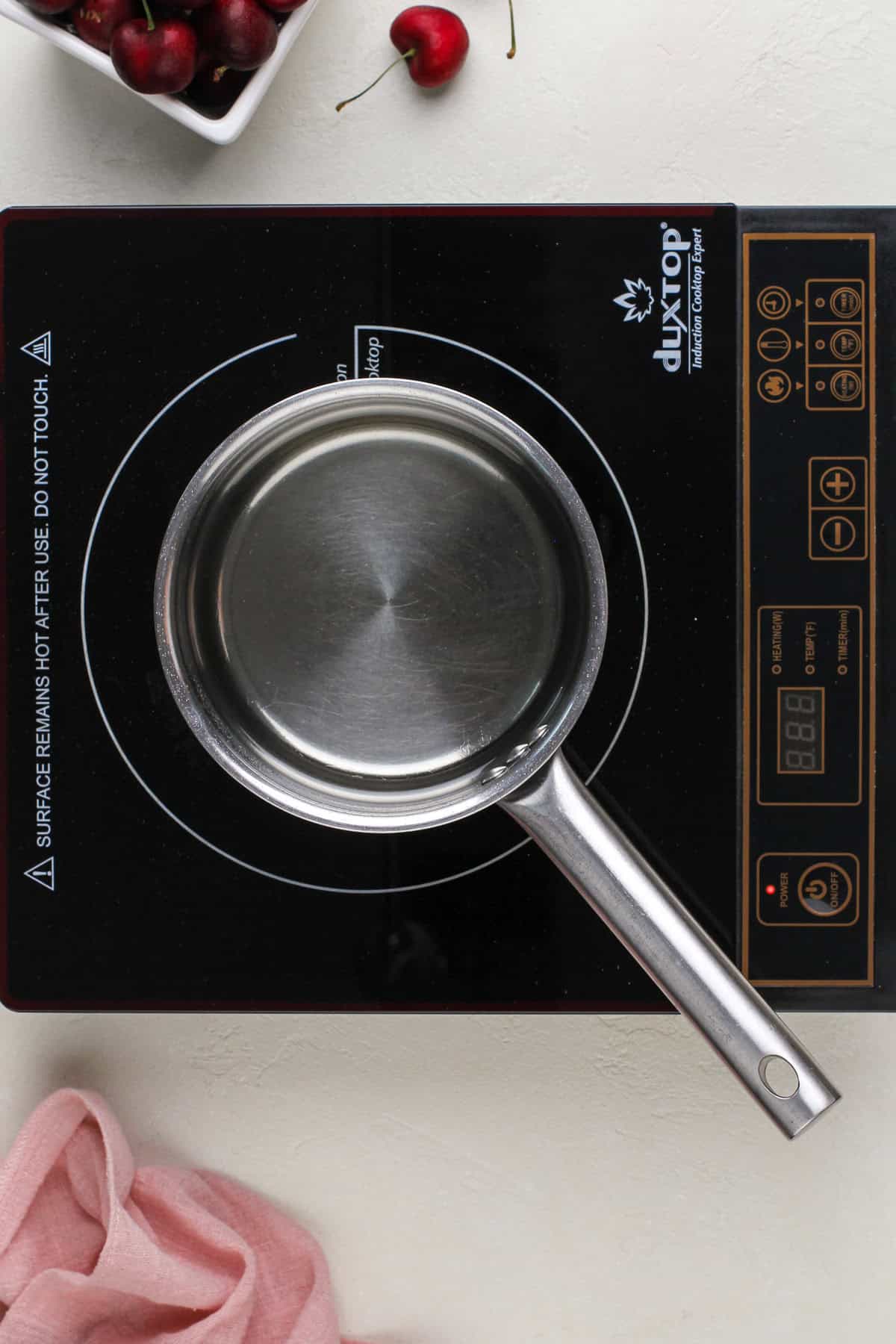 Simple syrup being simmered in a saucepan.