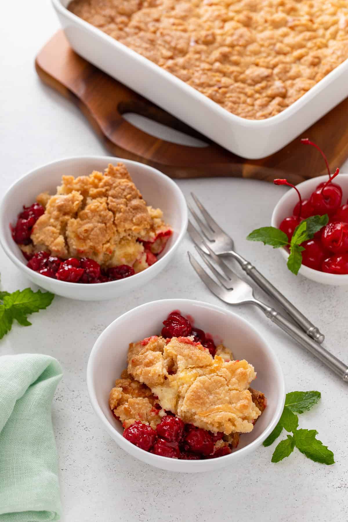 Two white bowls filled with cherry cheesecake cake.