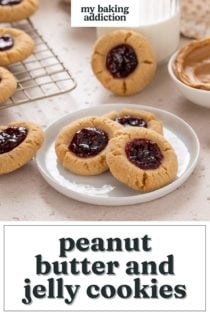 Peanut butter and jelly cookies arranged on a plate and wire rack with a glass of milk in the background. Text overlay includes recipe name.