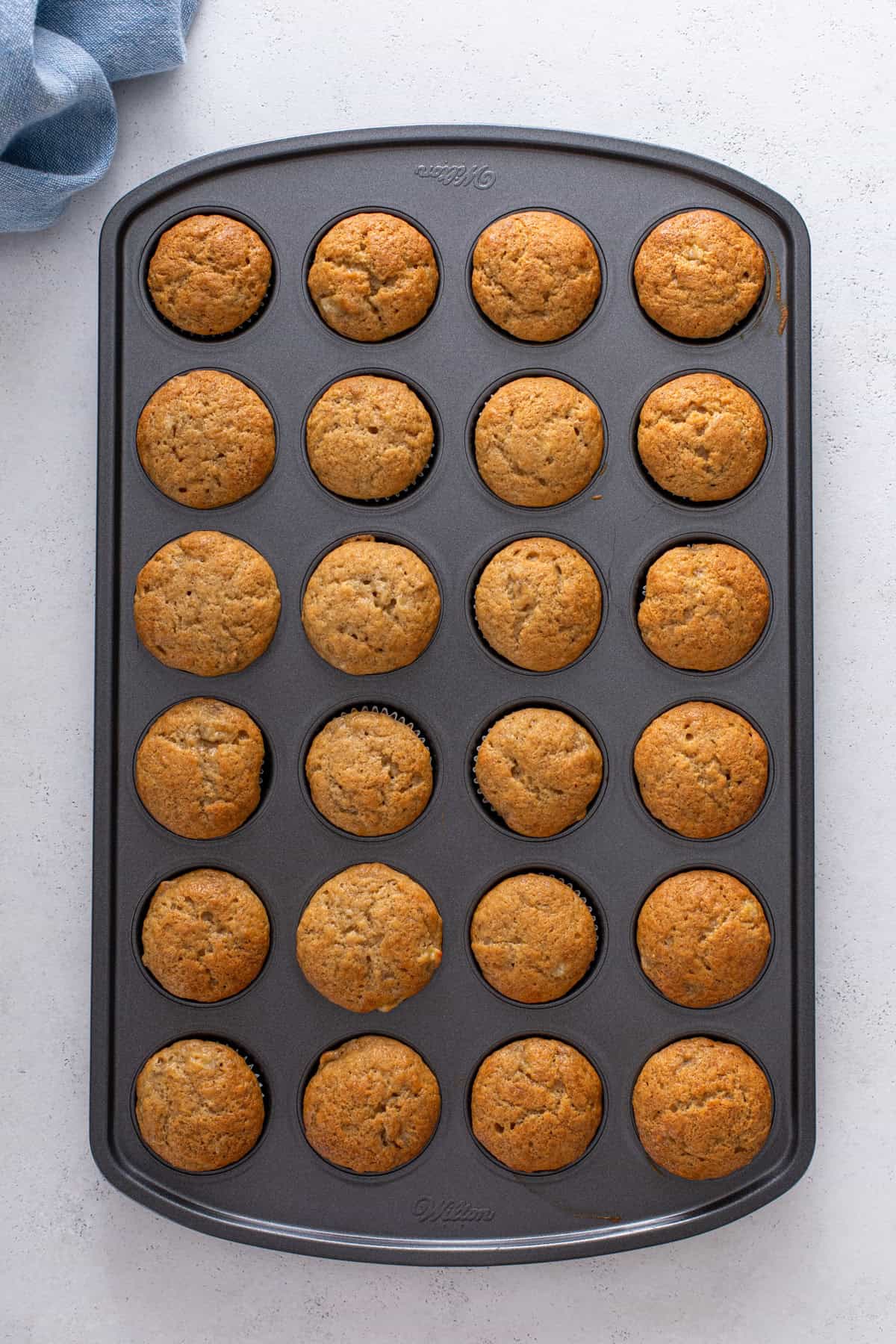 Baked mini banana muffins in a mini muffin tin.