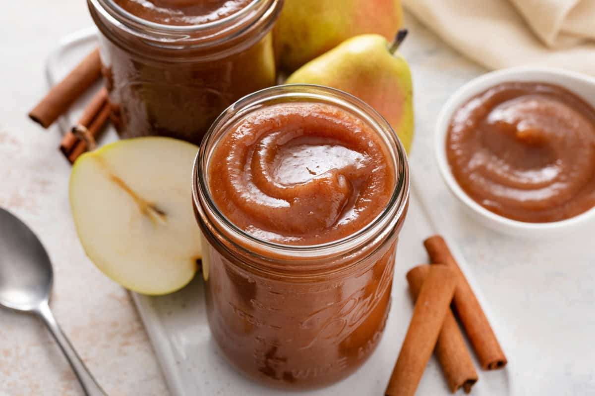 Close up of pear butter in a glass jar.