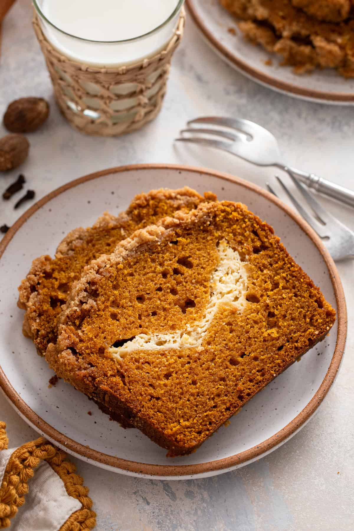 Close up of pumpkin cream cheese bread slices on a plate.