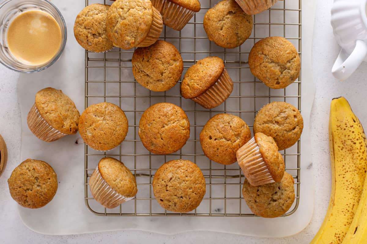Mini banana muffins cooling on a wire rack.