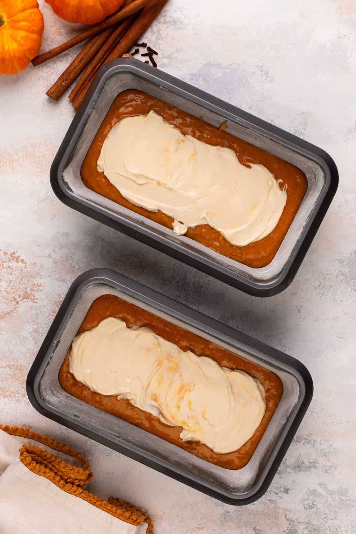 Cream cheese filling divided between two loaf pans.