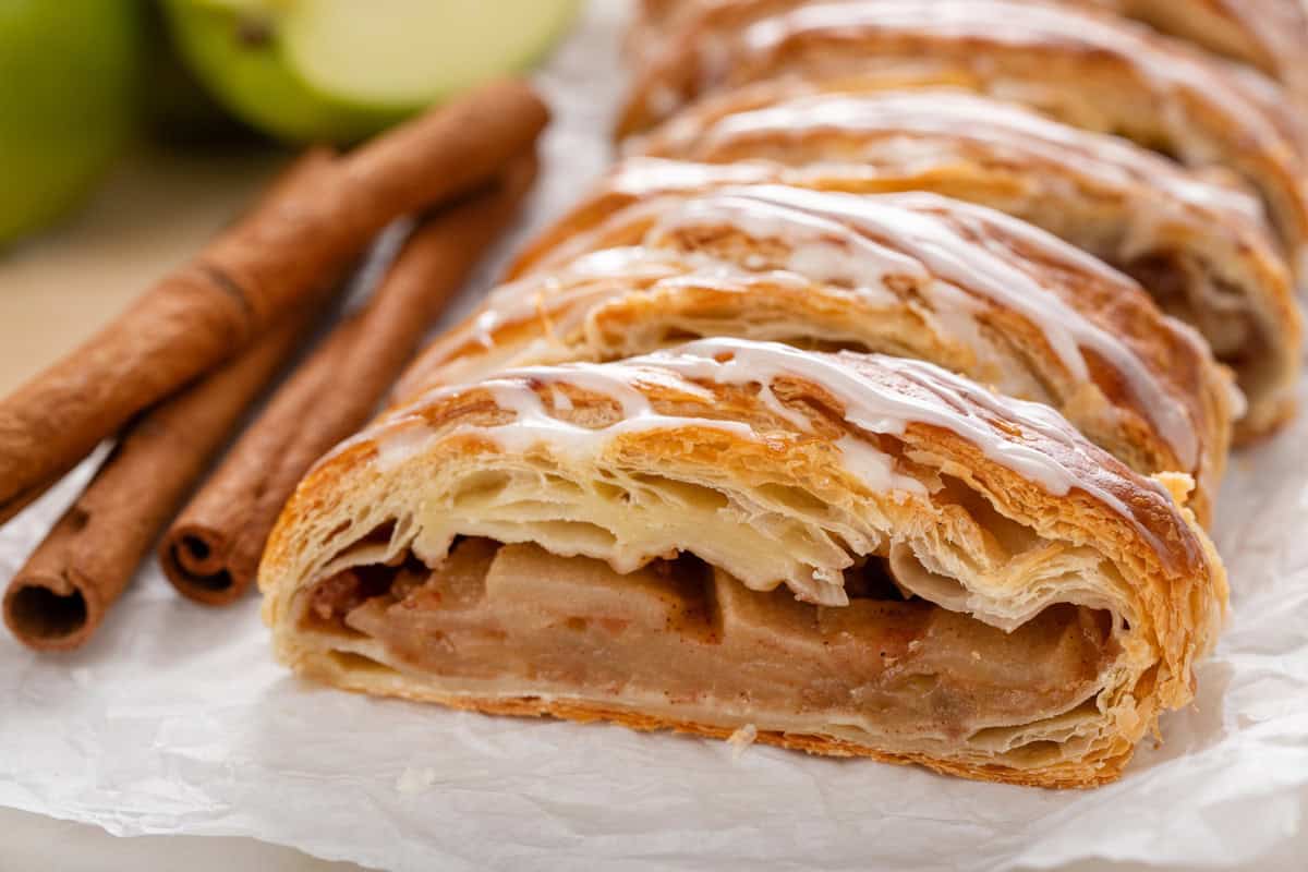 Cross view of a sliced puff pastry apple strudel.