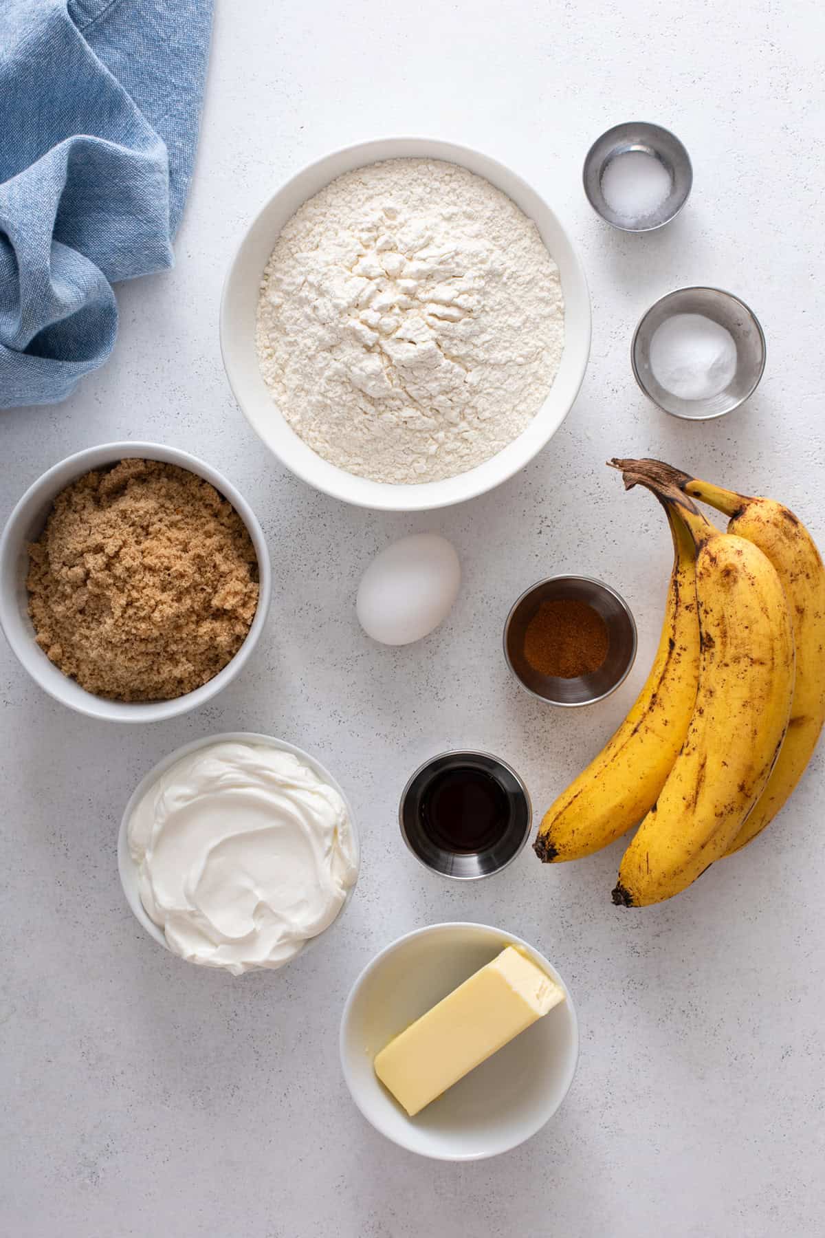 Mini banana muffin ingredients arranged on a countertop.