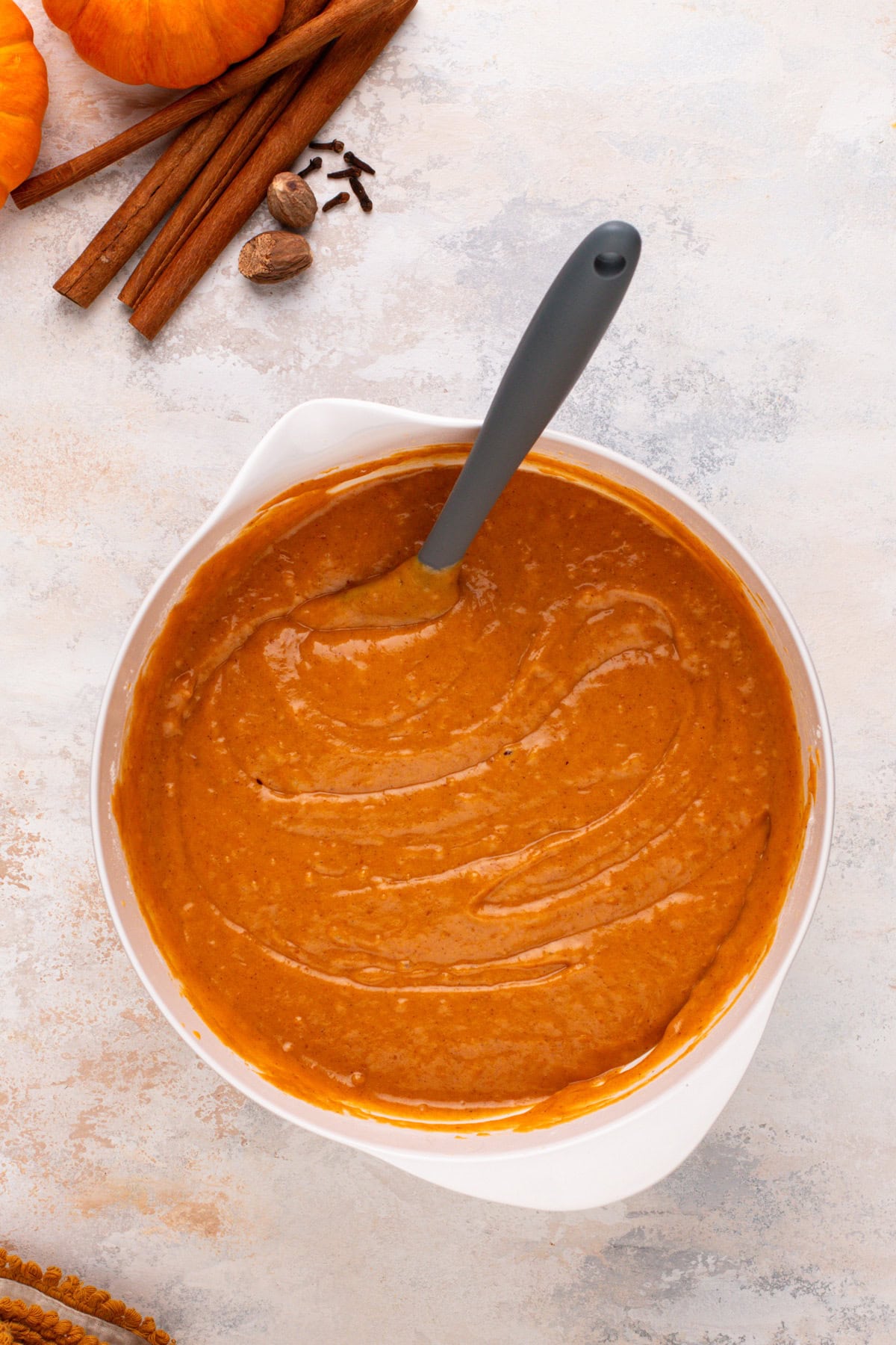 Pumpkin bread batter mixed in a white bowl.