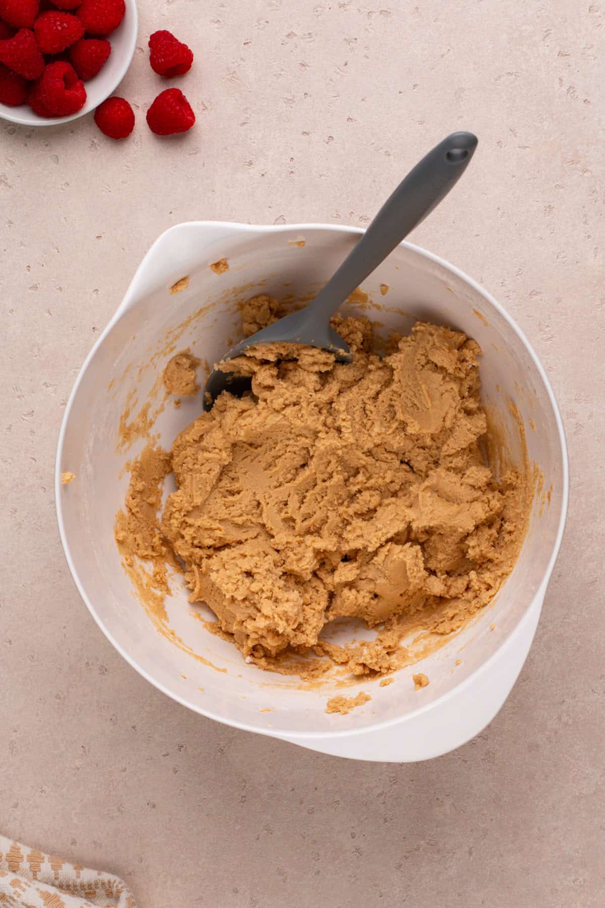 Dough for peanut butter and jelly cookies mixed in a white bowl.