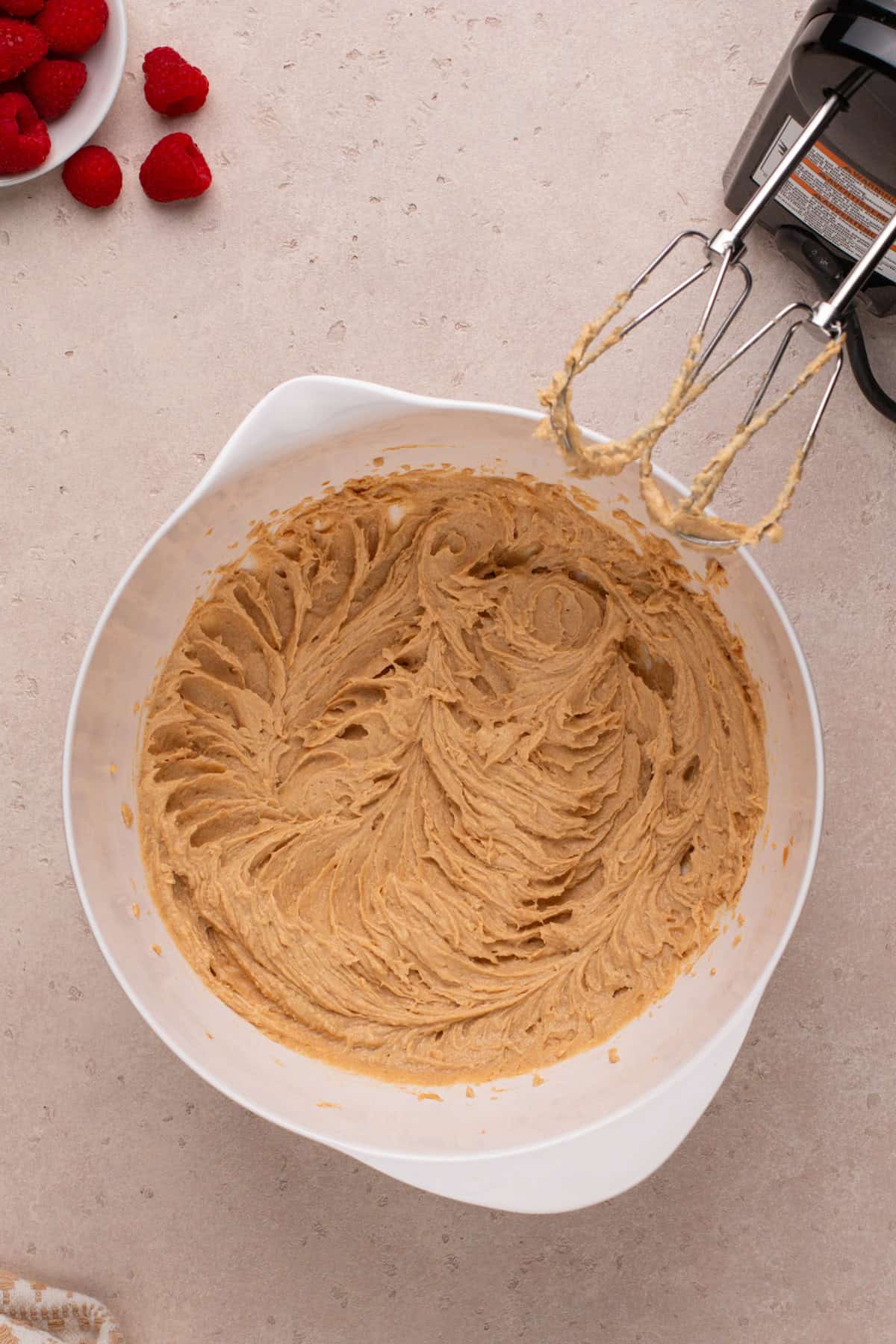 Wet ingredients for peanut butter and jelly cookies mixed in a white bowl.