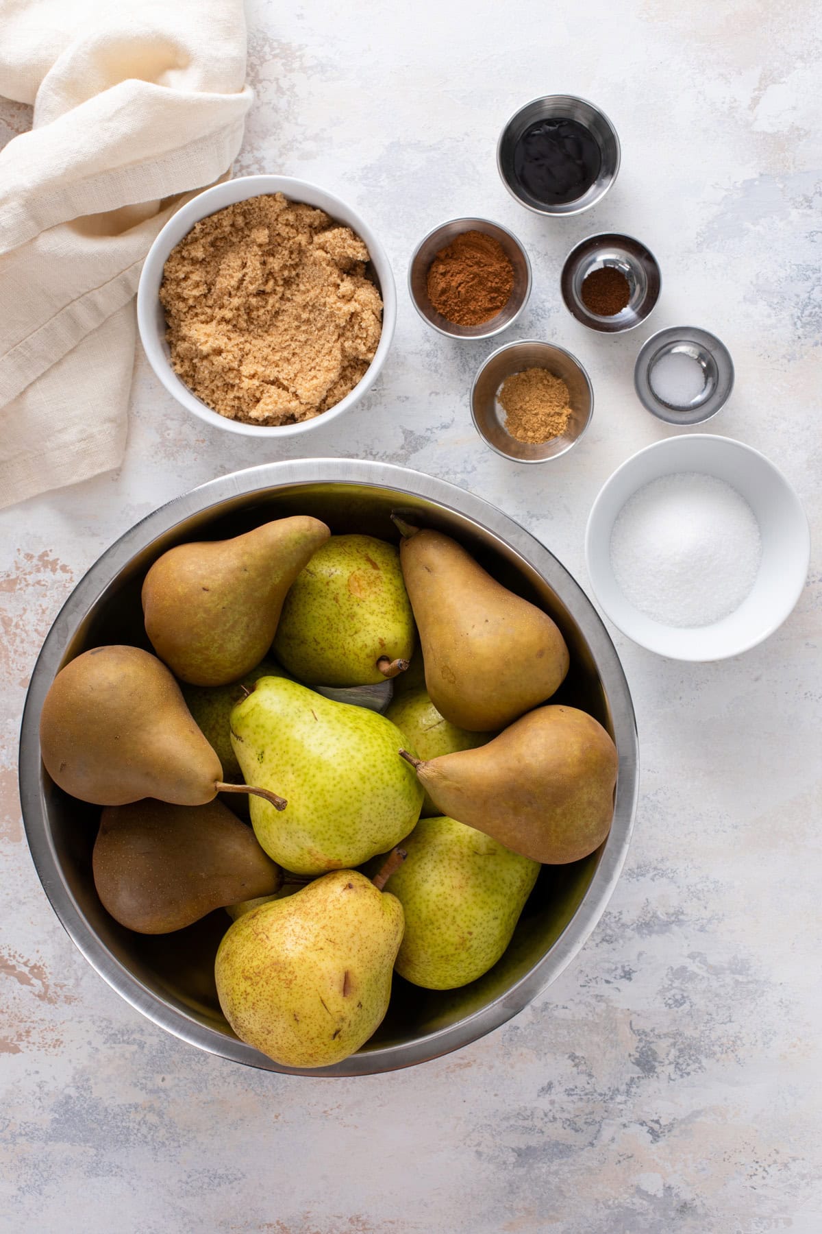 Pear butter ingredients arranged on a countertop.