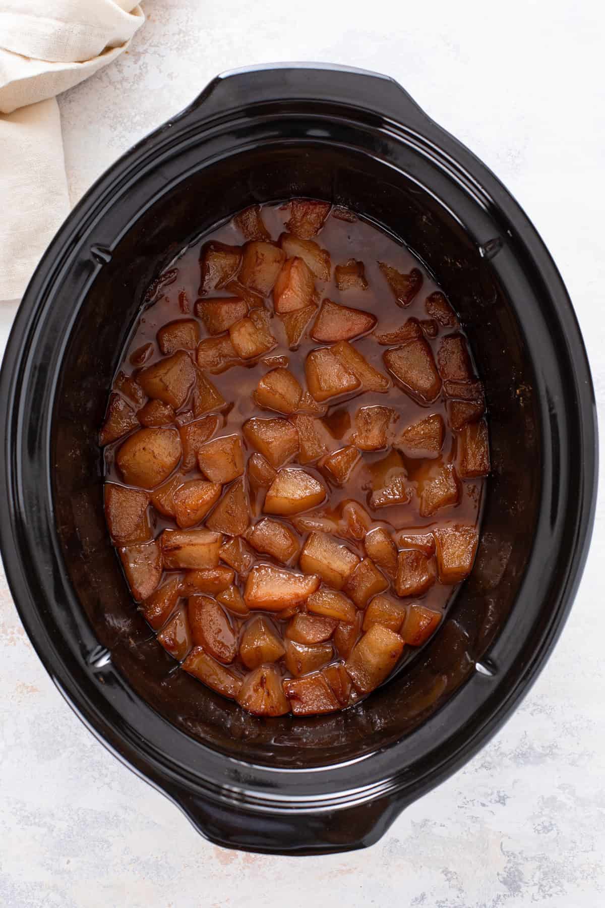 Cooked mixture for pear butter in the crock of a slow cooker before pureeing.