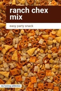 Close up of ranch chex mix spread into a layer on a sheet pan. Text overlay includes recipe name.