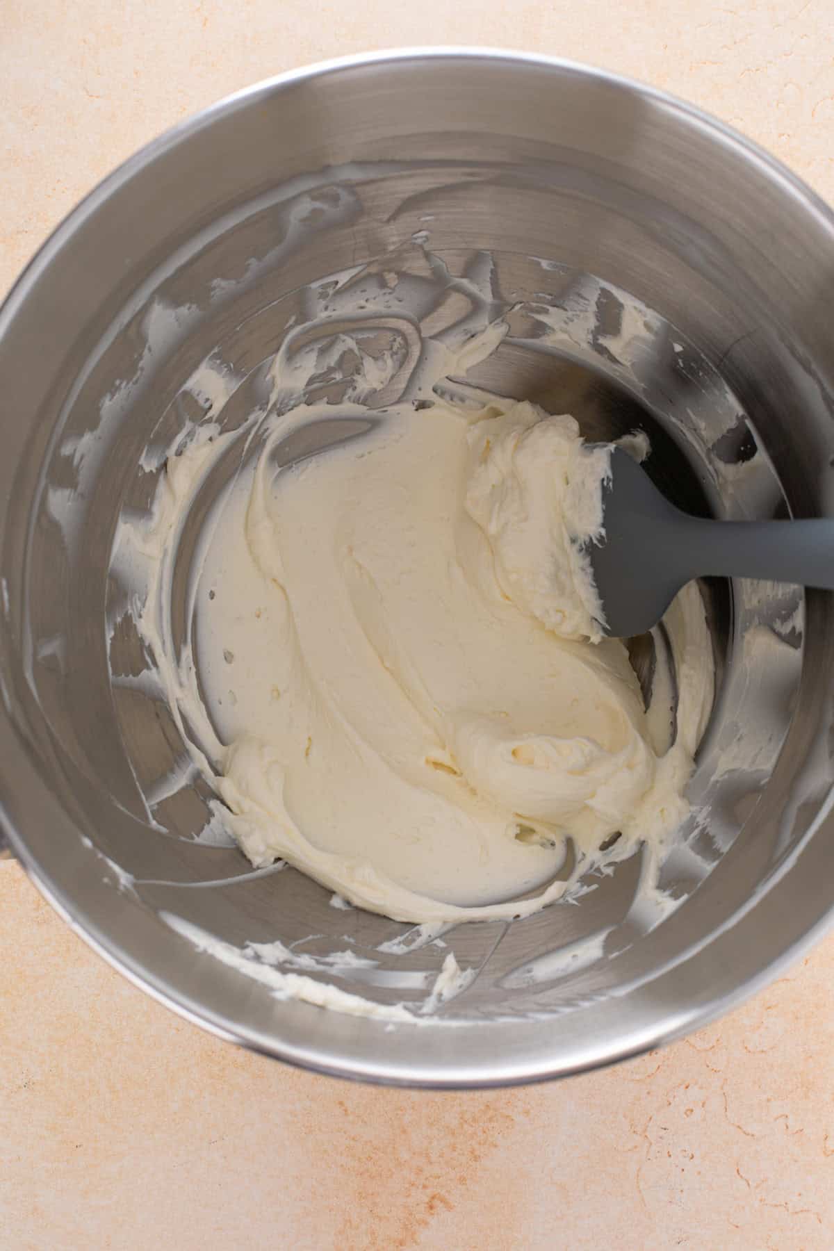Beaten cream cheese in a mixing bowl.