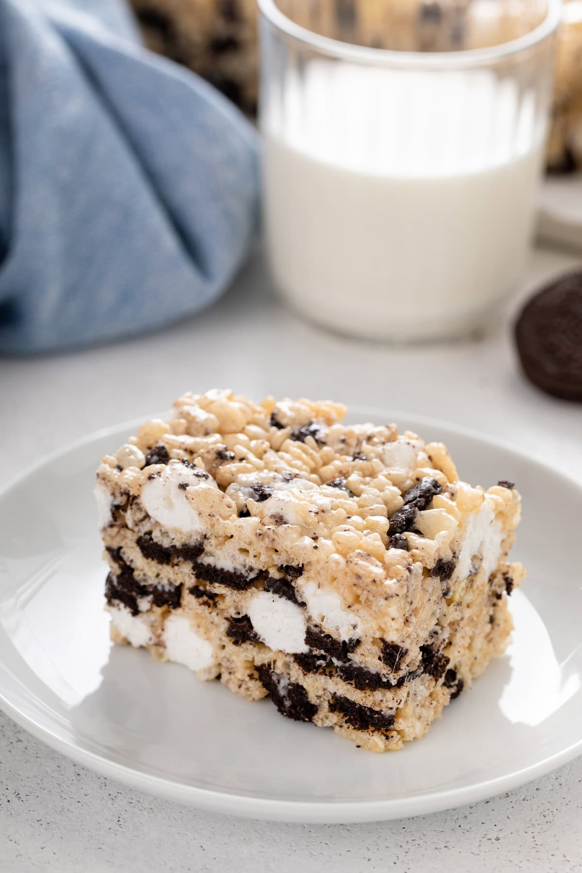 White plate holding an oreo rice krispie treat.