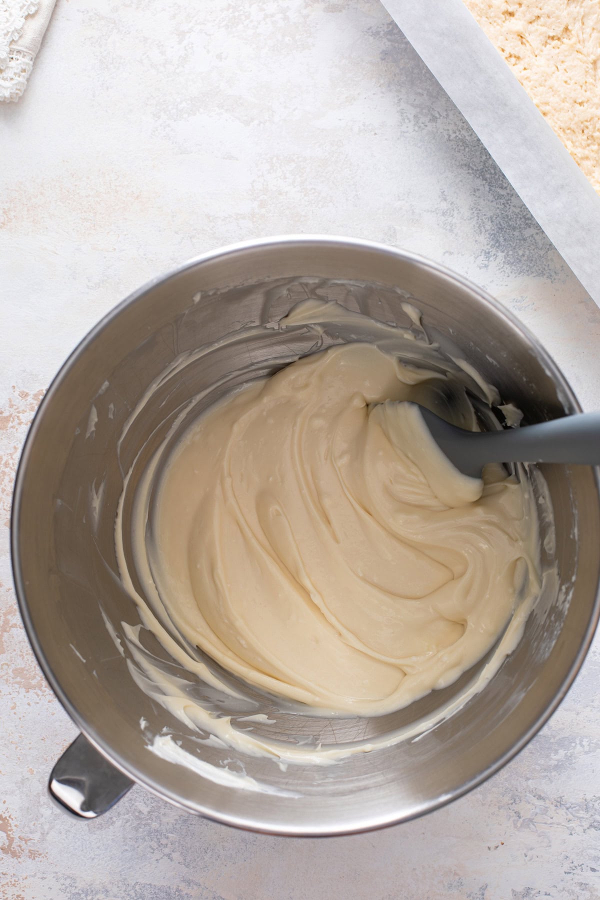Cream cheese filling for coffee cake mixed in a metal bowl.