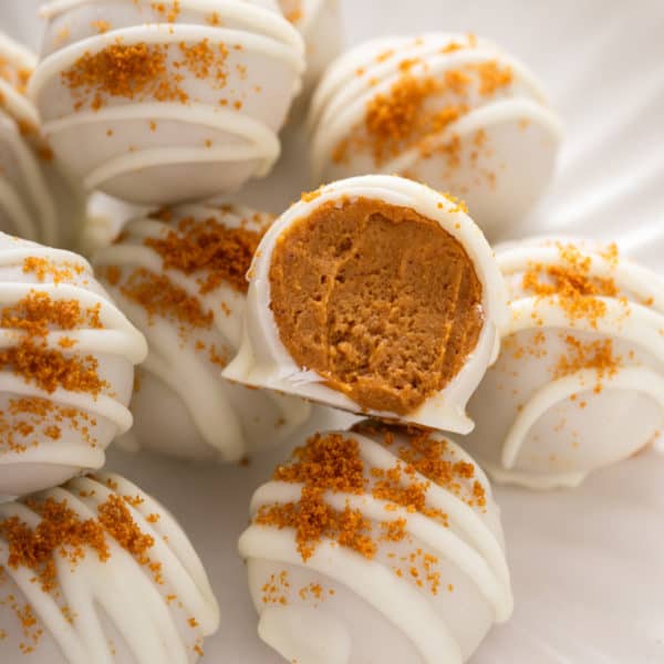 Close up of halved pumpkin cheesecake bite.