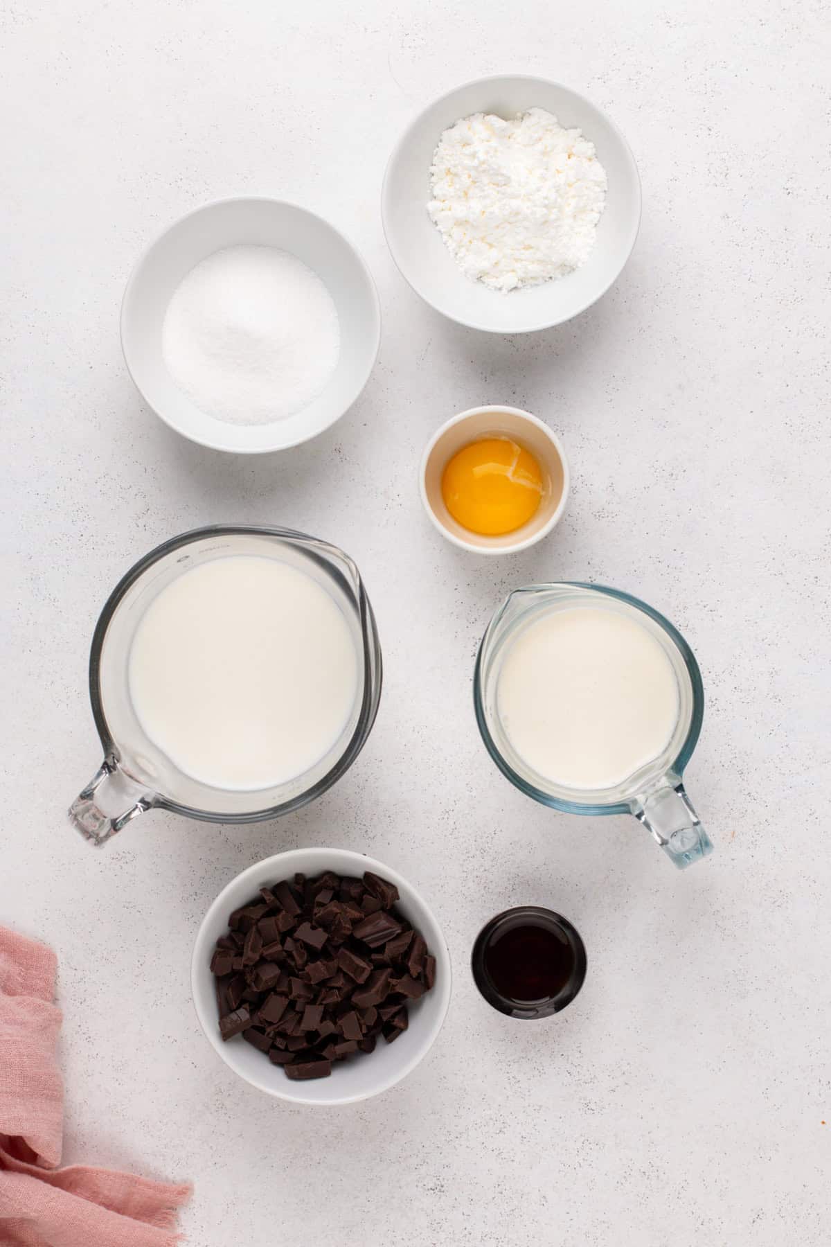 Homemade chocolate pudding ingredients arranged on a countertop.
