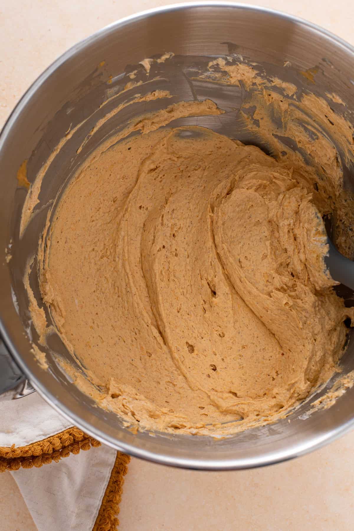 Filling for no-bake pumpkin pie in a metal bowl.