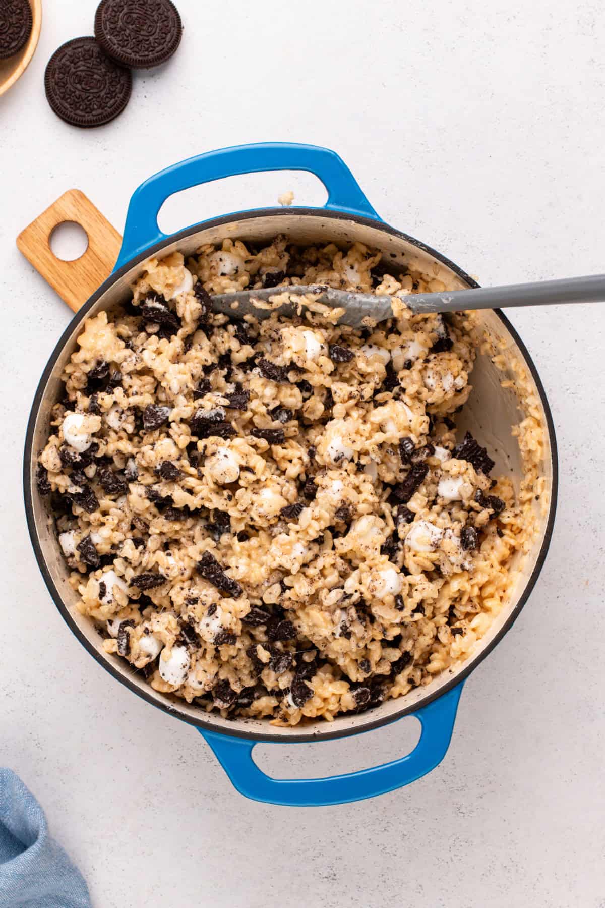 Chopped oreos and mini marshmallows added to rice krispie treat mixture in a dutch oven.