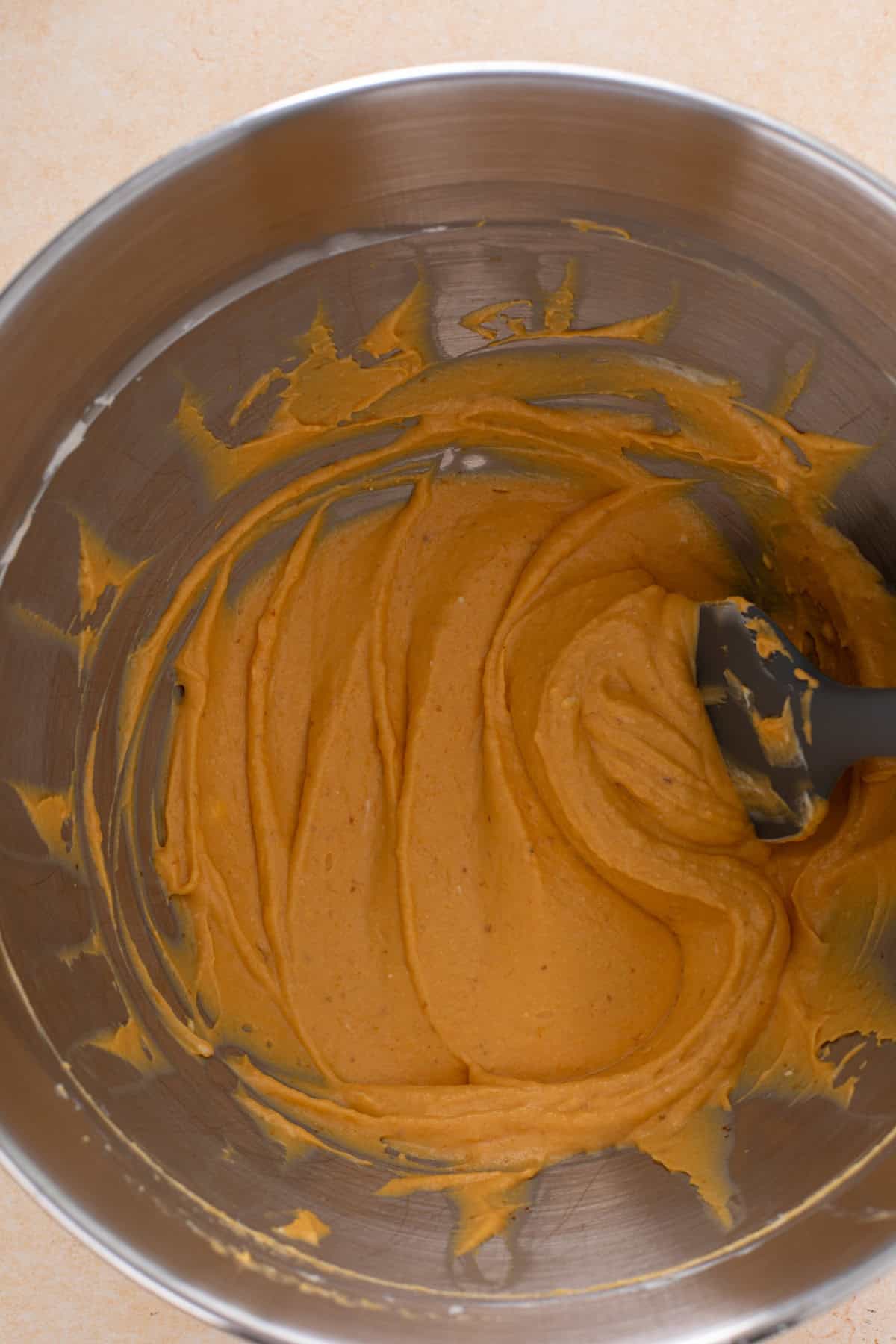Pumpkin puree mixed with cream cheese in a bowl.