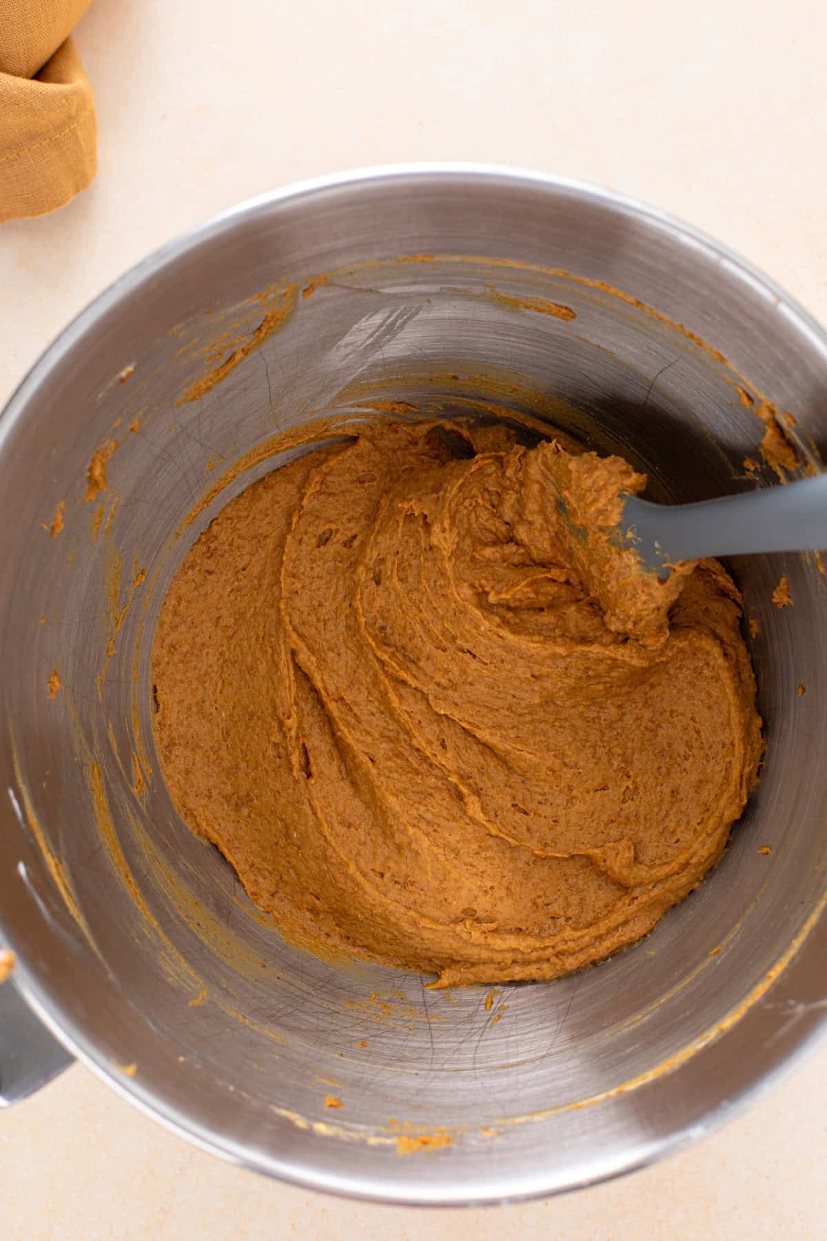 Filling for pumpkin cheesecake balls mixed in a bowl.