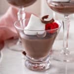 Side view of a serving of chocolate pudding in a glass.