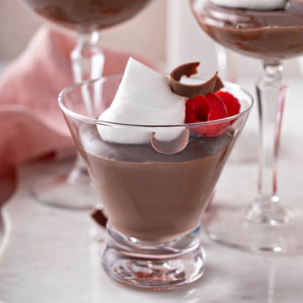 Side view of a serving of chocolate pudding in a glass.