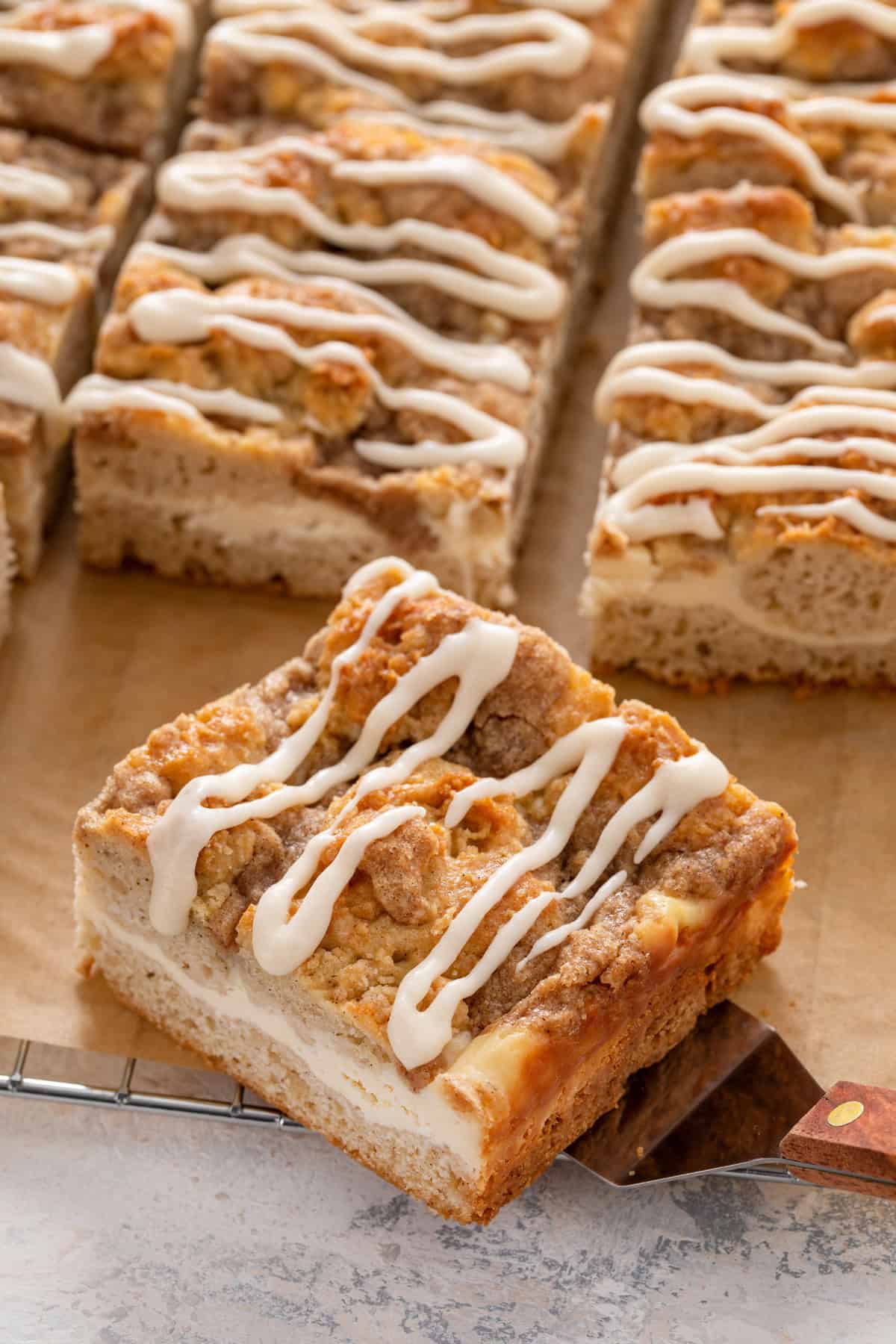 Slice of cream cheese coffee cake resting on a cake server.