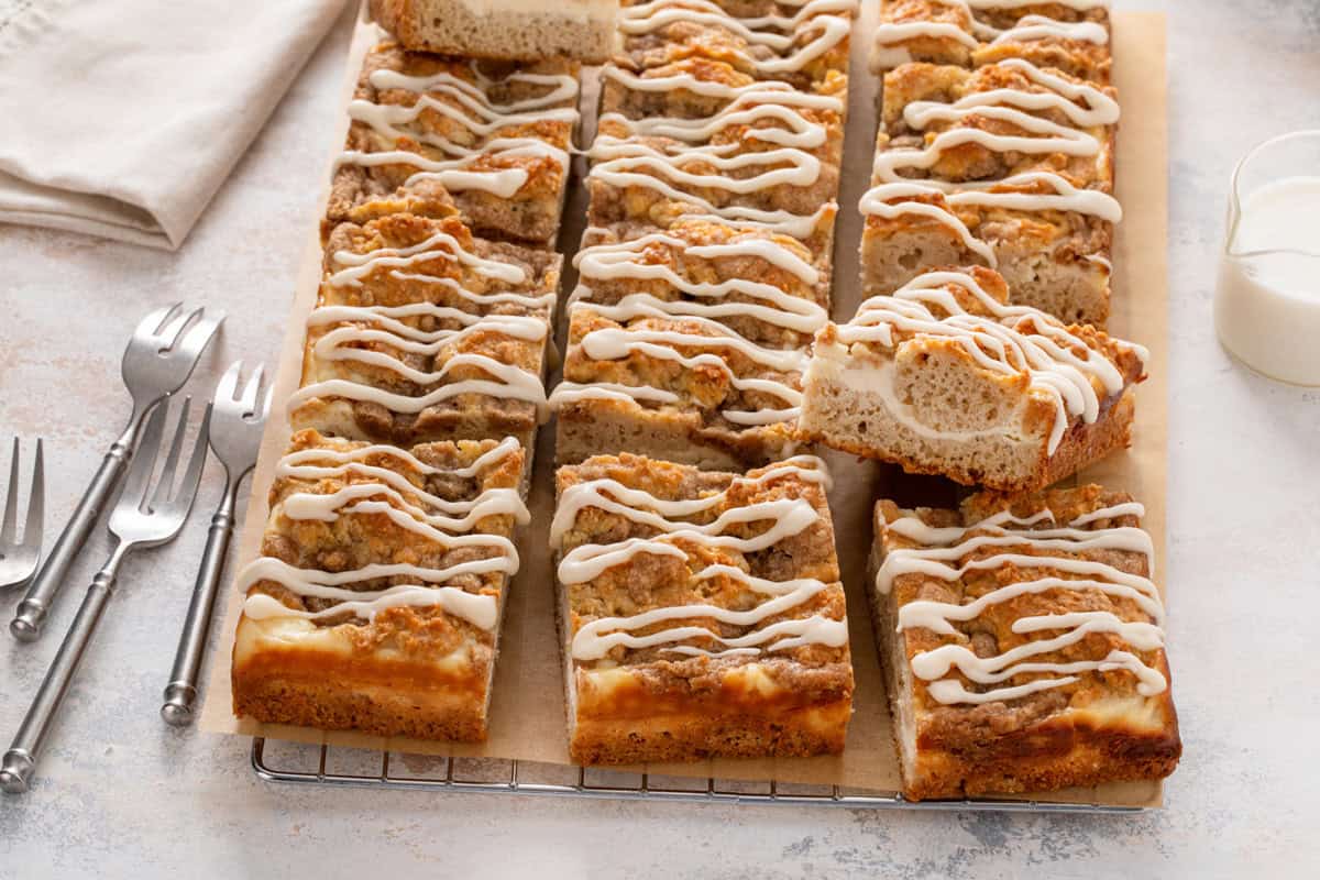 Sliced cream cheese coffee cake on a wire rack.