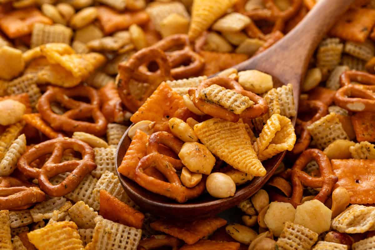 Spoonful of ranch chex mix in a wooden spoon.