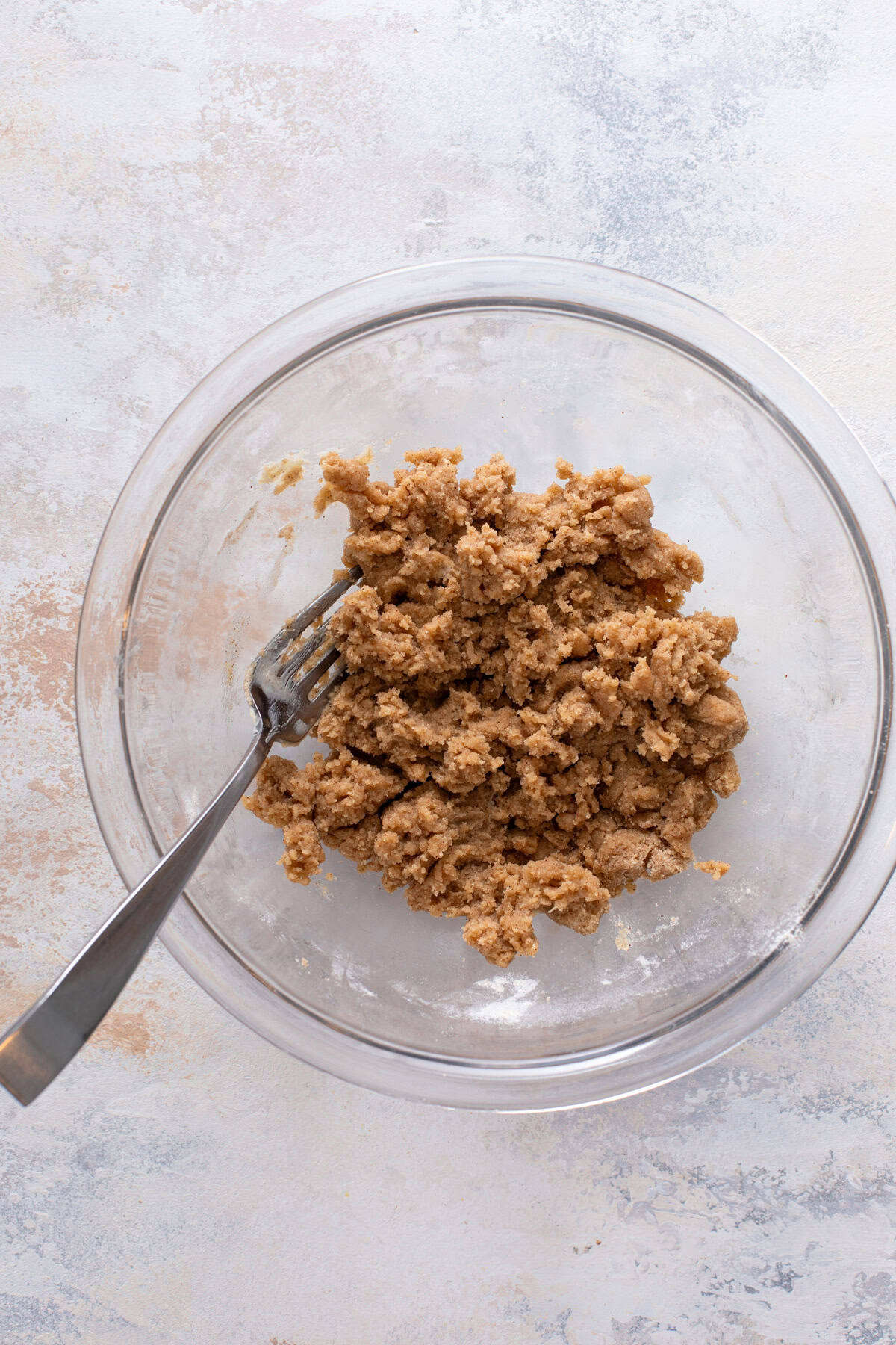 Brown sugar streusel mixed in a glass bowl.