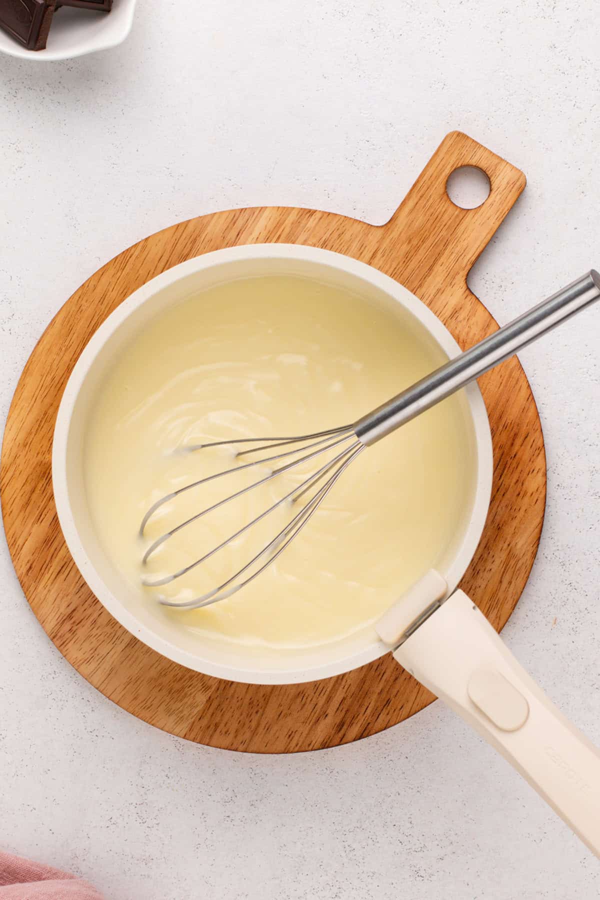 Thickened chocolate pudding base in a saucepan.