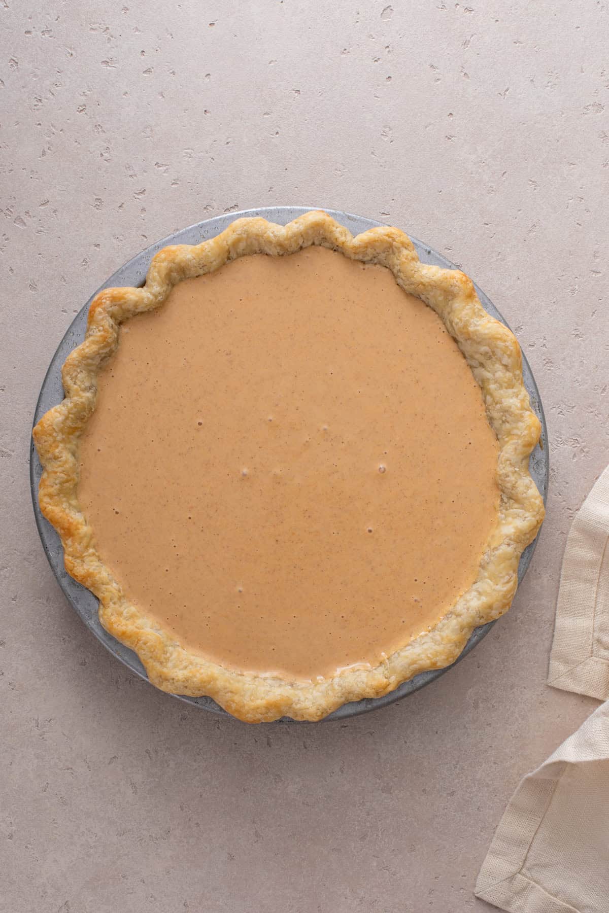 Unbaked pumpkin cheesecake pie ready to go in the oven.