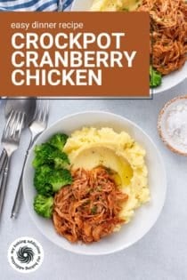Overhead view of two plates of cranberry chicken with mashed potatoes and broccoli. Text overlay includes recipe name.