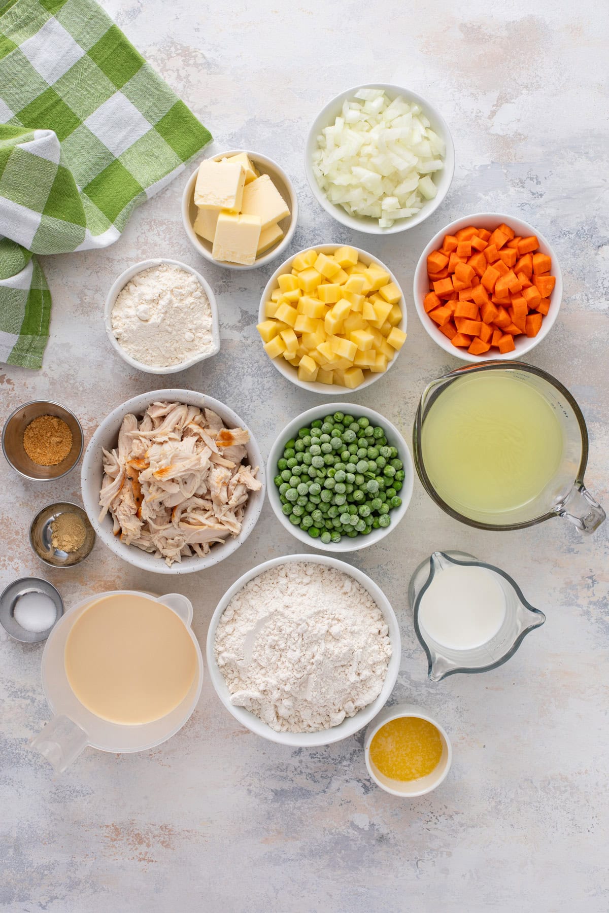 Ingredients for bisquick chicken pot pie arranged on a countertop.