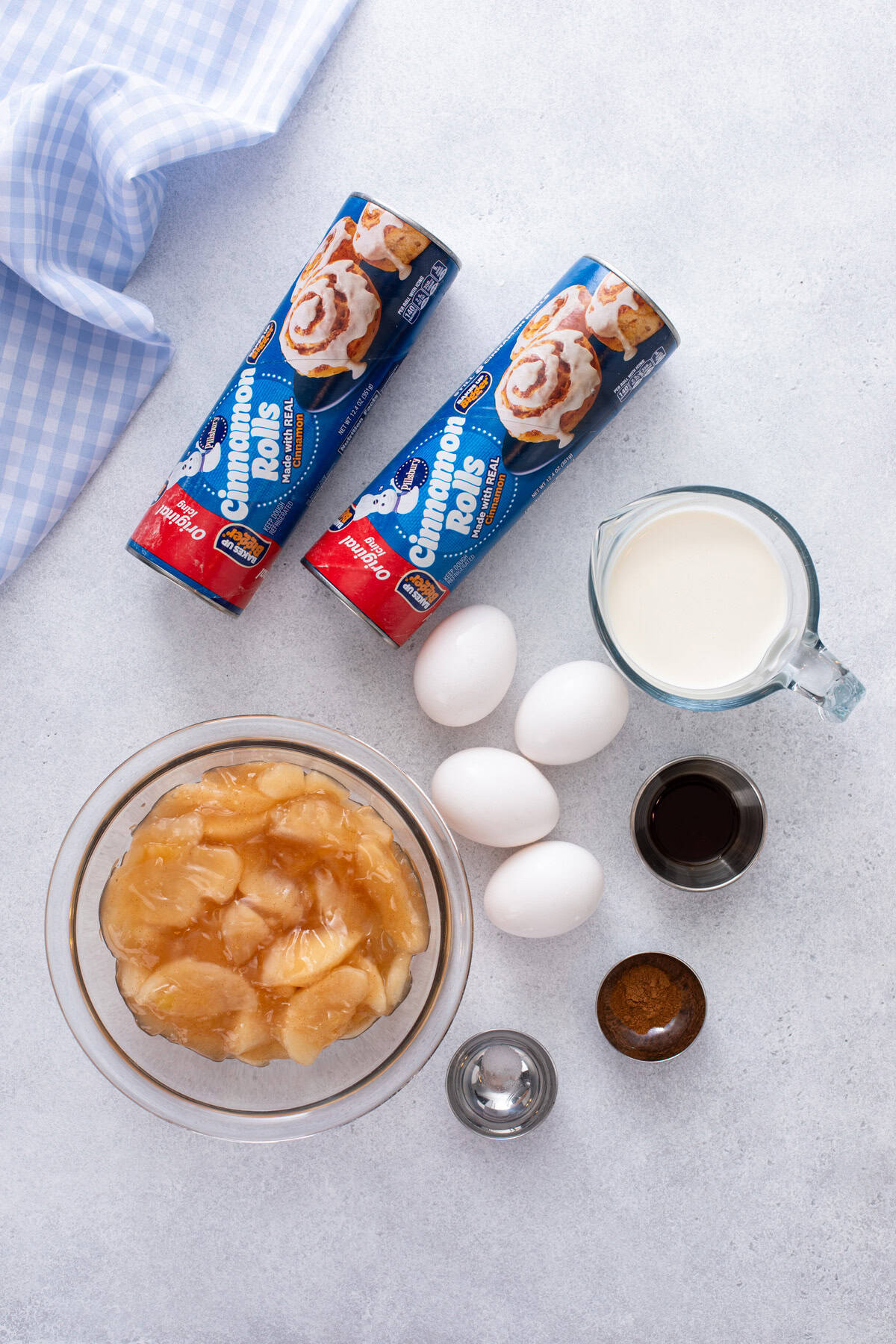 Ingredients for cinnamon roll casserole arranged on a countertop.