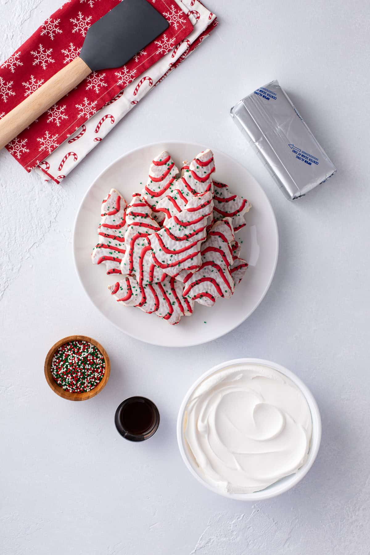 Overhead view of ingredients for little debbie christmas tree cake dip arranged on a counter.