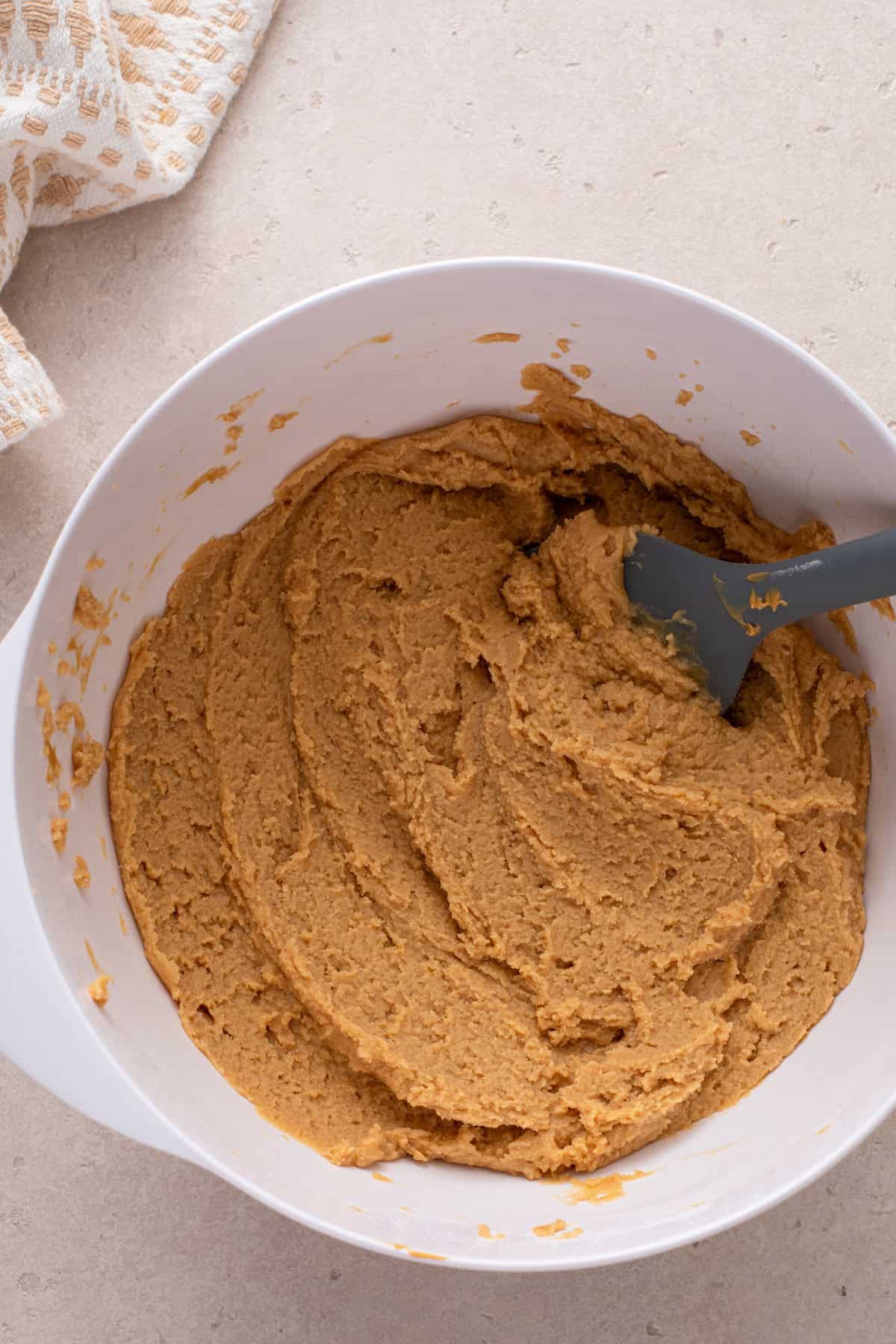 Peanut butter fudge mixture in a white mixing bowl.