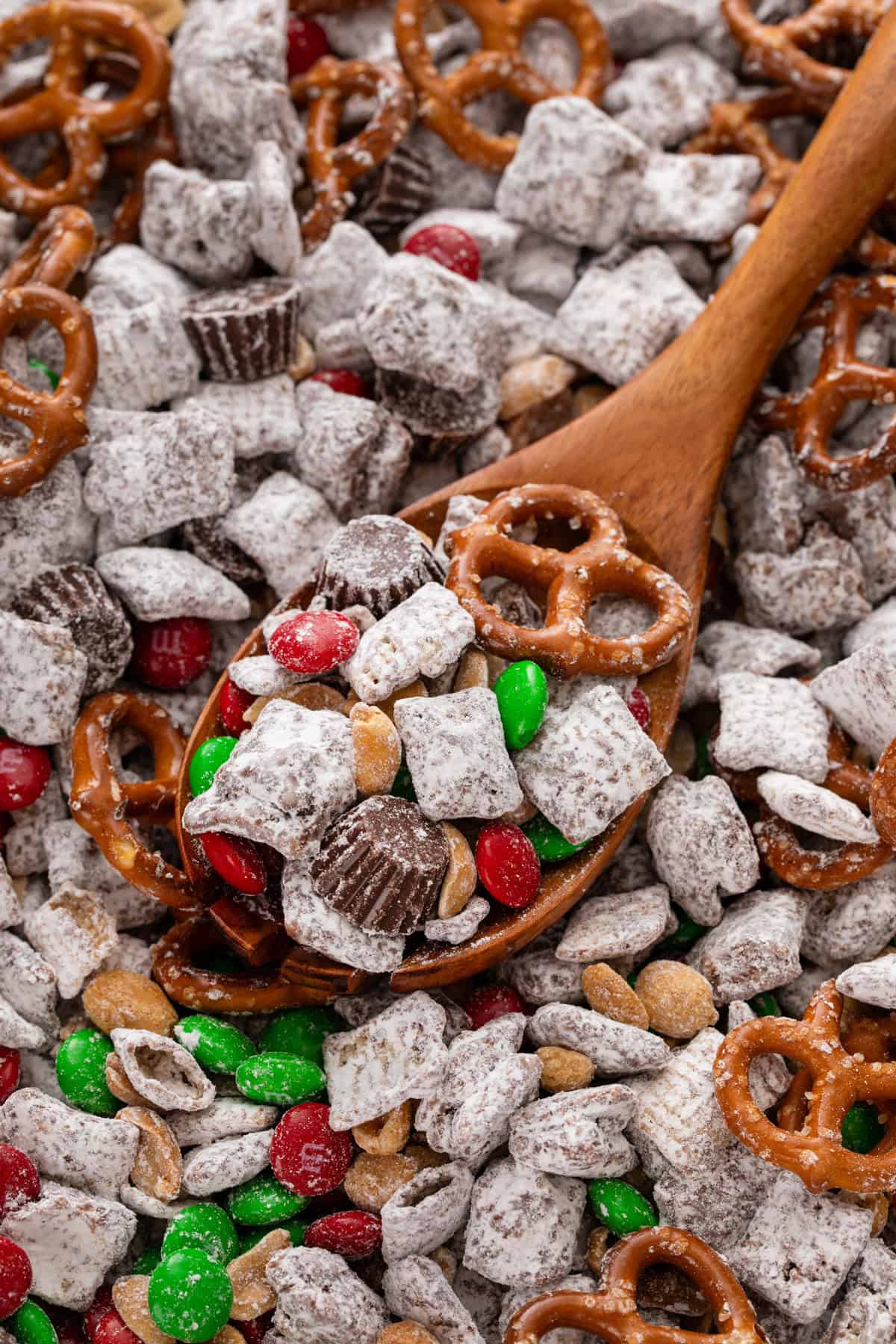 Wooden spoon scooping up reindeer chow.