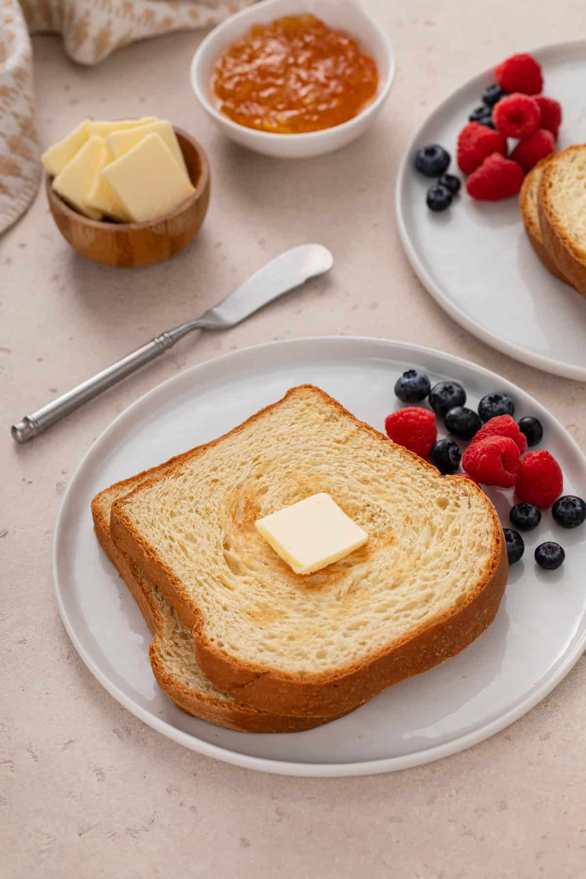 Toasted slices of potato bread on a white plate.
