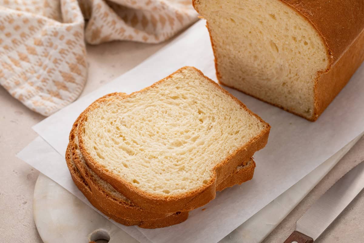Sliced loaf of potato bread on a cutting board.
