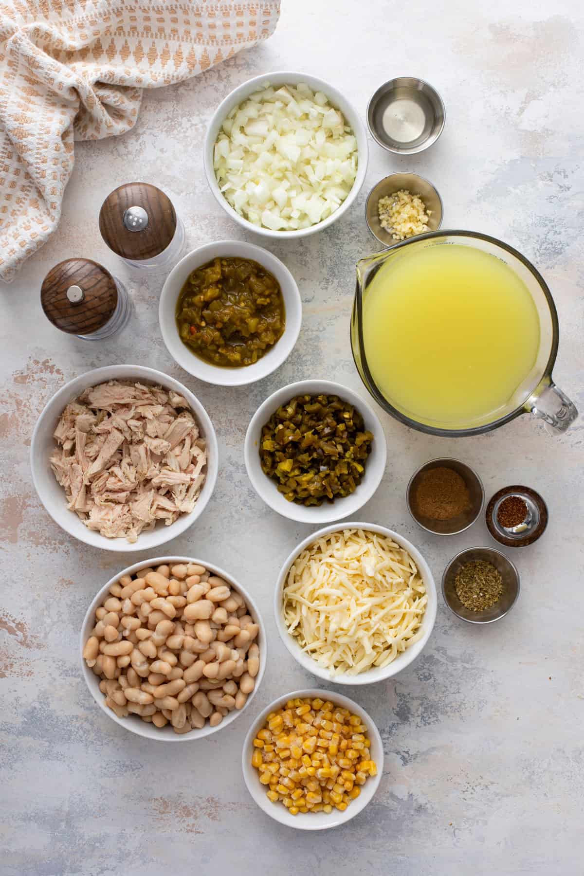 Ingredients for white chicken chili arranged on a countertop.