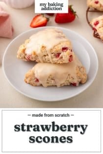 Two strawberry scones arranged on a white plate, with fresh berries in the background. Text overlay includes recipe name.