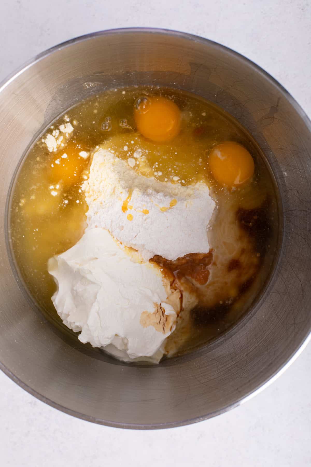 Ingredients for easy yellow cake added to a mixing bowl.