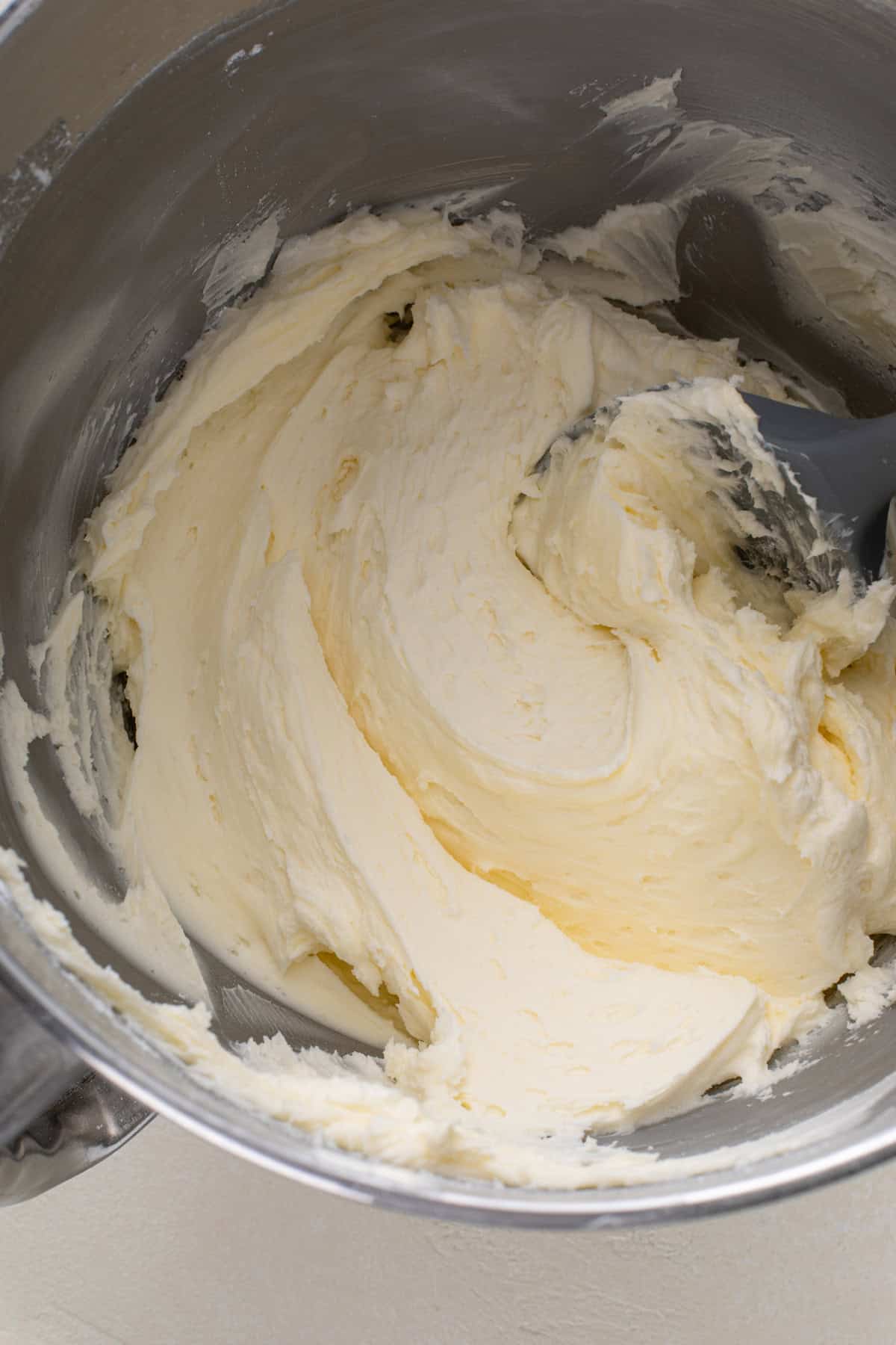 Sugar cookie frosting that has been combined in a stand mixer.