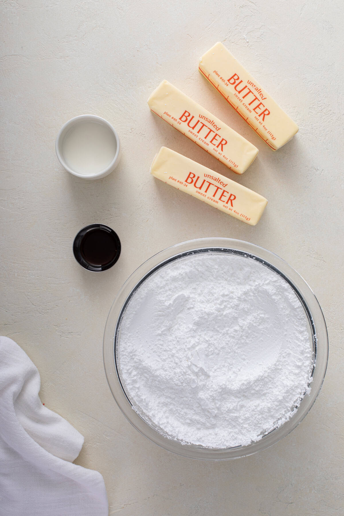 ingredients for sugar cookie frosting arranged on a countertop.