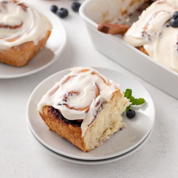 Blueberry sweet roll on a white plate.