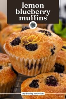 Lemon blueberry muffins stacked on top of each other on a wire rack. Text overlay includes recipe name.